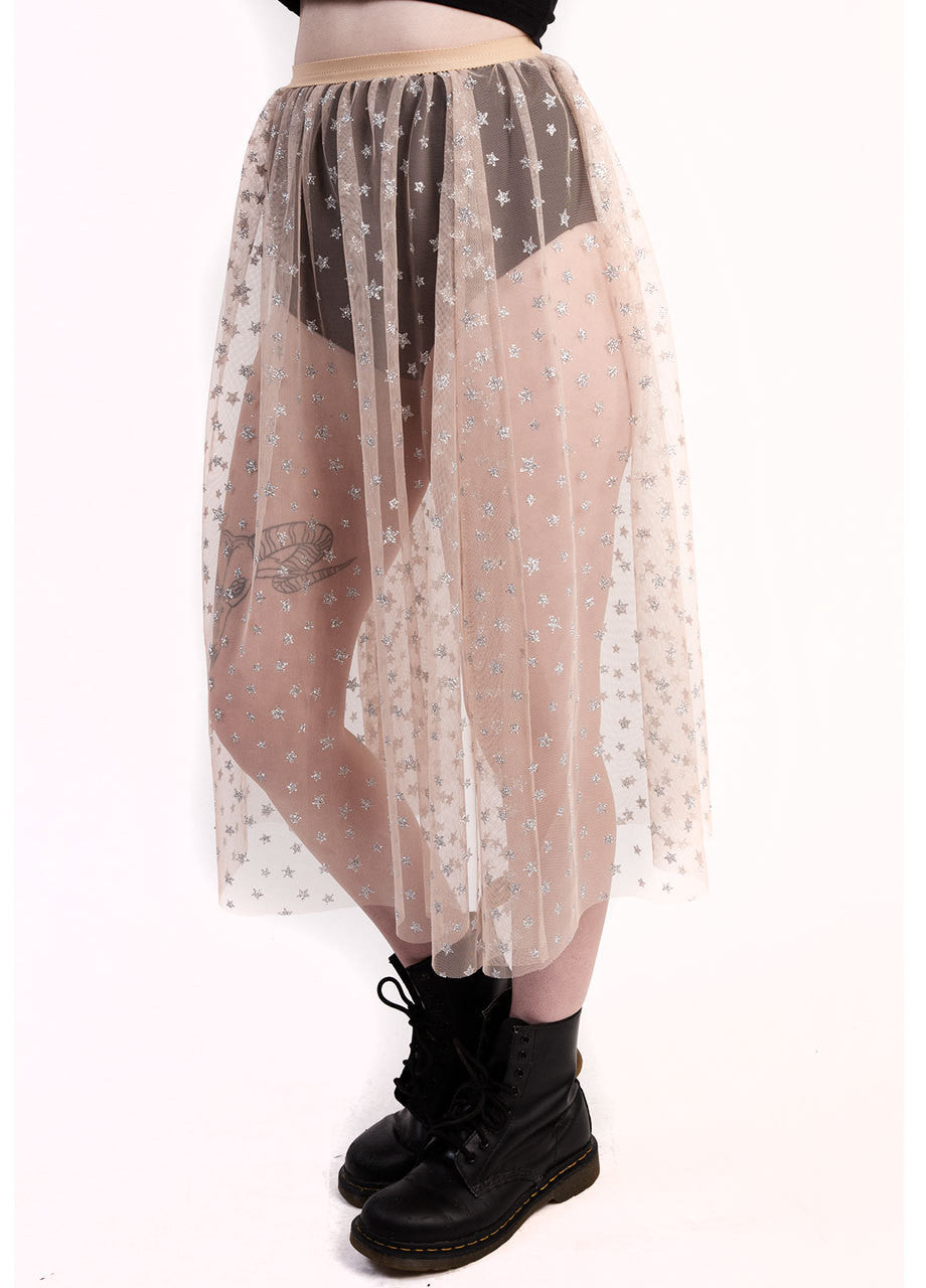 castles couture luna glitter skirt with star graphic print on sheer nude tulle material, worn over black velvet hot pants