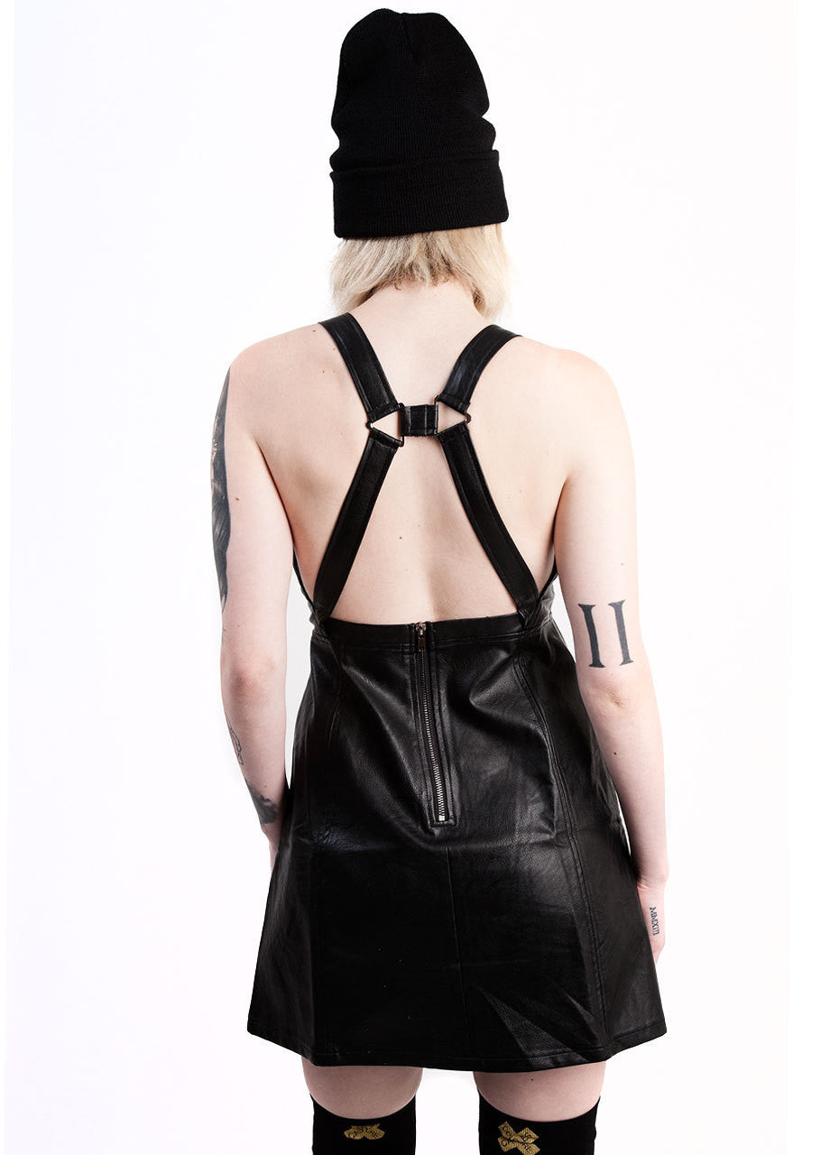 Evil Twin hold me back pinnie dress in black vegan leather with harness design