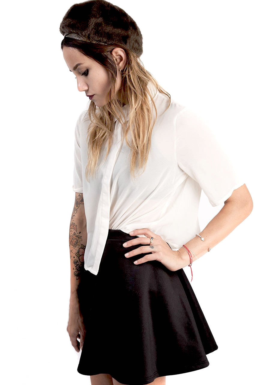 Cropped button down shirt in off white worn with high waist skirt