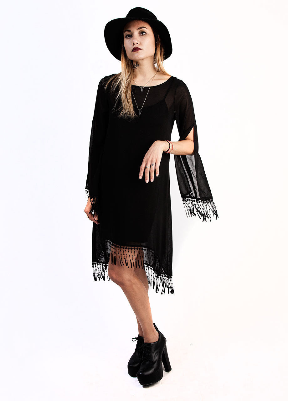 witchy little black dress with sheer high low design and fringe