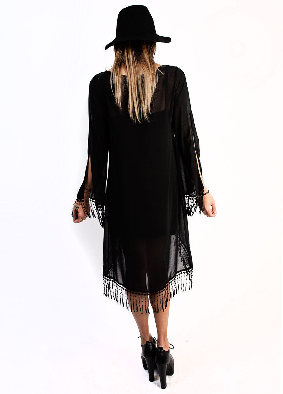 sheer black asymmetrical midi dress with fringe and slitted long sleeves